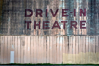 Vintage Drive-In Theatre Sign on Weathered Wall