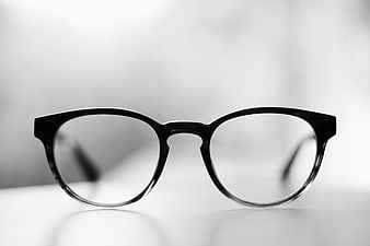 Black Eyeglasses on White Surface in Monochrome