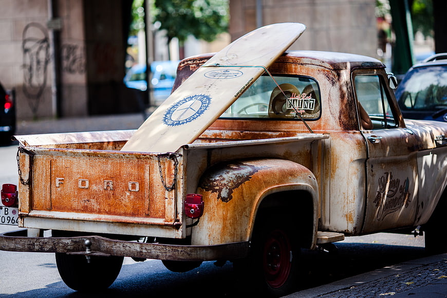 Vintage Rusty Ford Pickup Truck with Surfboard