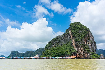 Stilt Houses at Base of Limestone Karst Island in Thailand