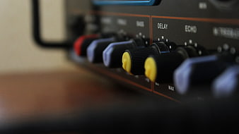 Close-up of guitar amplifier control knobs and dials