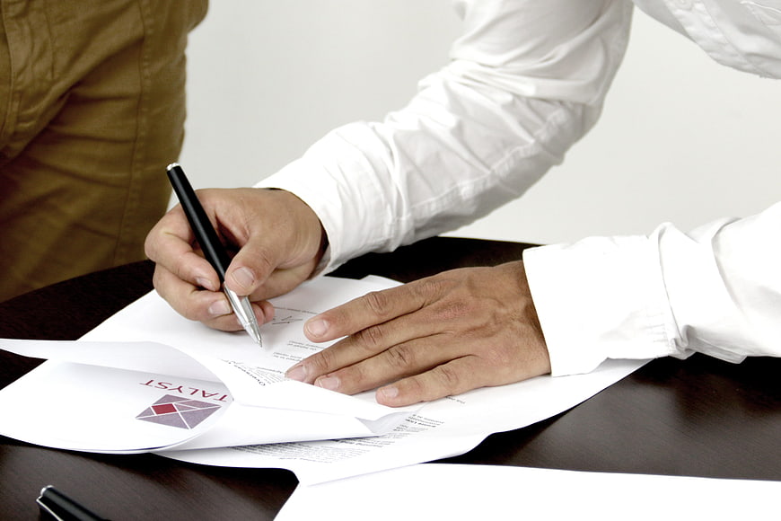 Close-up of hands signing a business contract document