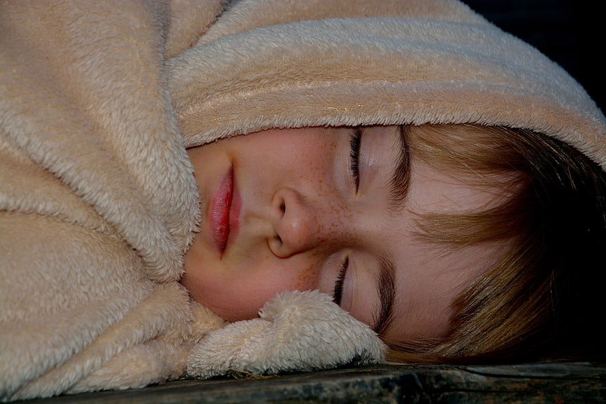 Sleeping Child Wrapped In Soft Fleece Blanket