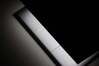 Close-up of sleek silver laptop edge with power button