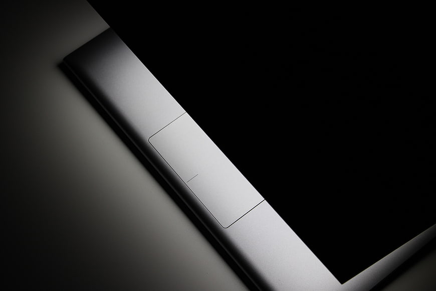 Close-up of sleek silver laptop edge with power button