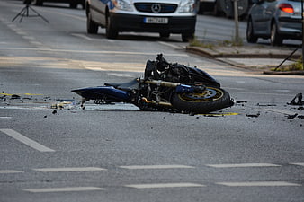 Wrecked Motorcycle Lying on Asphalt Road After Traffic Accident