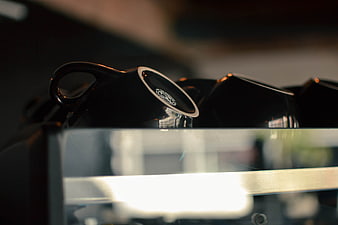 Close-up of black coffee cups on espresso machine