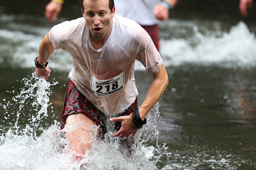 Man Running Through Water in Obstacle Course Race