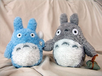 Blue and Gray Totoro Plush Toys Sitting on Beige Fabric