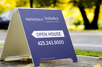 Blue Sotheby's International Realty Open House Sign on Sidewalk