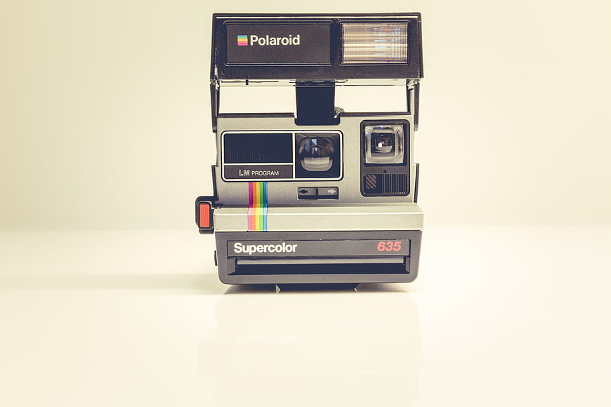 Vintage Polaroid Supercolor 635 Instant Camera on White Background