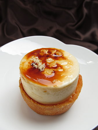Individual Custard Tart With Caramelized Sugar Topping On White Plate