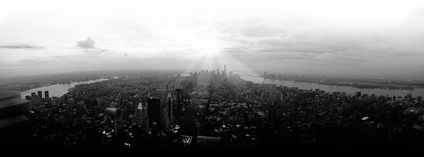 Panoramic Black and White New York City Skyline with Sun Rays