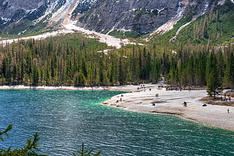 Turquoise Mountain Lake with Sandy Beach and Visitors