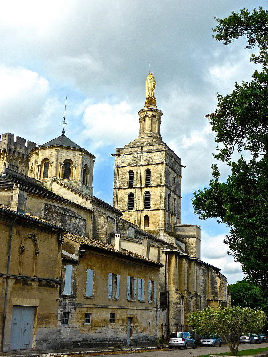 Historic Cathedral with Golden Statue Tower and Stone Architecture