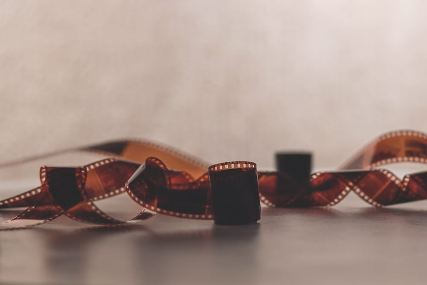 Vintage Film Strip and Roll on Wooden Table