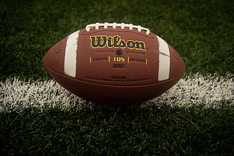 Wilson football on artificial turf field