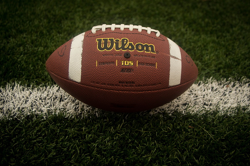Wilson football on artificial turf field