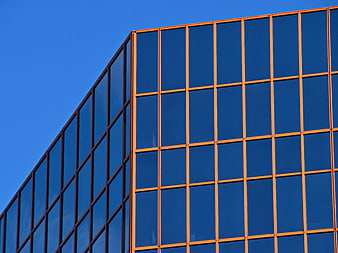 Modern Glass Office Building Facade with Blue Sky