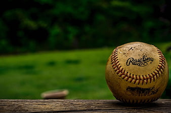 Vintage Baseball on Wooden Fence