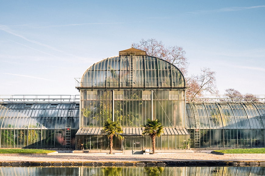 Grand Glass Greenhouse Architecture with Water Reflection