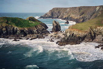 Dramatic Coastal Landscape with Cliffs, Sea Stack, and Waves