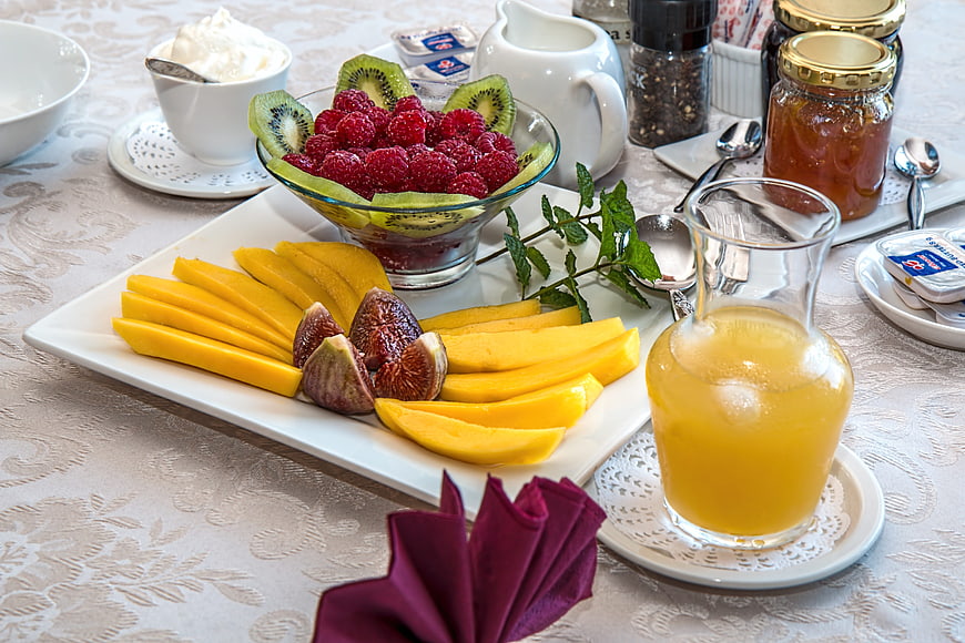 Healthy breakfast spread with fresh fruit and orange juice