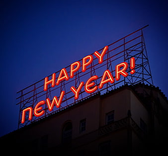 Red Neon Happy New Year Sign Against Deep Blue Night Sky