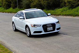 White Audi A6 Sedan Driving on Asphalt Road