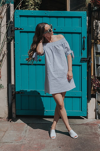 Woman in Striped Dress Posing by Teal Door