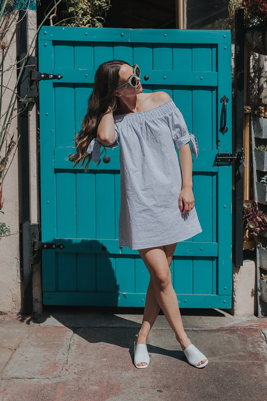 Woman in Striped Dress Posing by Teal Door