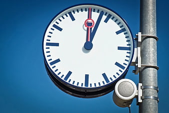 Blue and White Station Clock Against Clear Sky