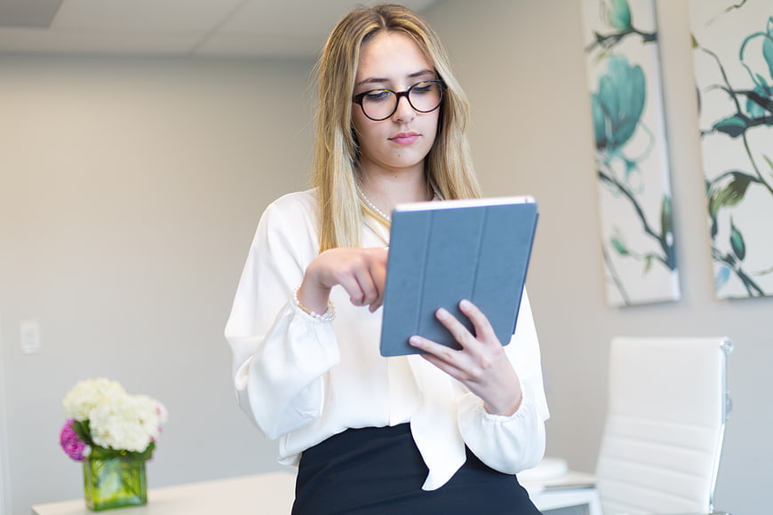 Professional woman using tablet in modern office