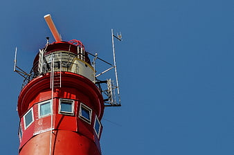 Red Lighthouse Tower Against Blue Sky