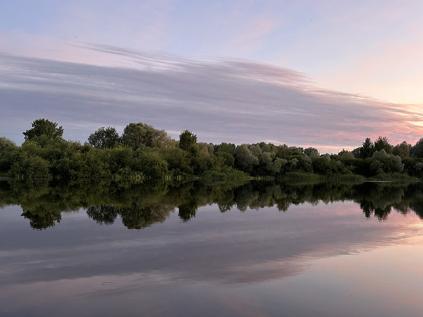 Serene Lake Reflection at Sunset with Pink Clouds
