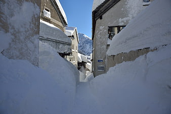 Narrow Snow-Covered Alley in Swiss Alps Village