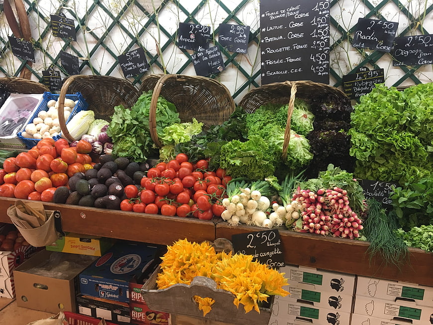 Fresh organic vegetables and flowers at a French market stall