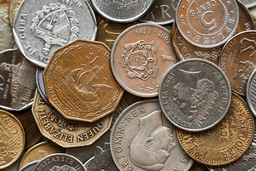 Close-up of mixed international coins and currency