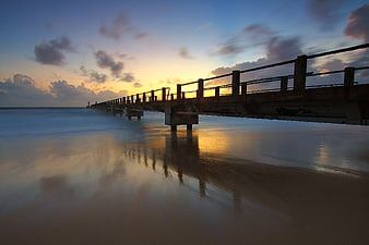 Long Exposure Sunset Pier on Sandy Beach