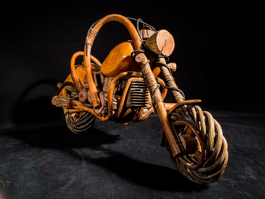 Handcrafted Wooden Motorcycle Sculpture on Black Background
