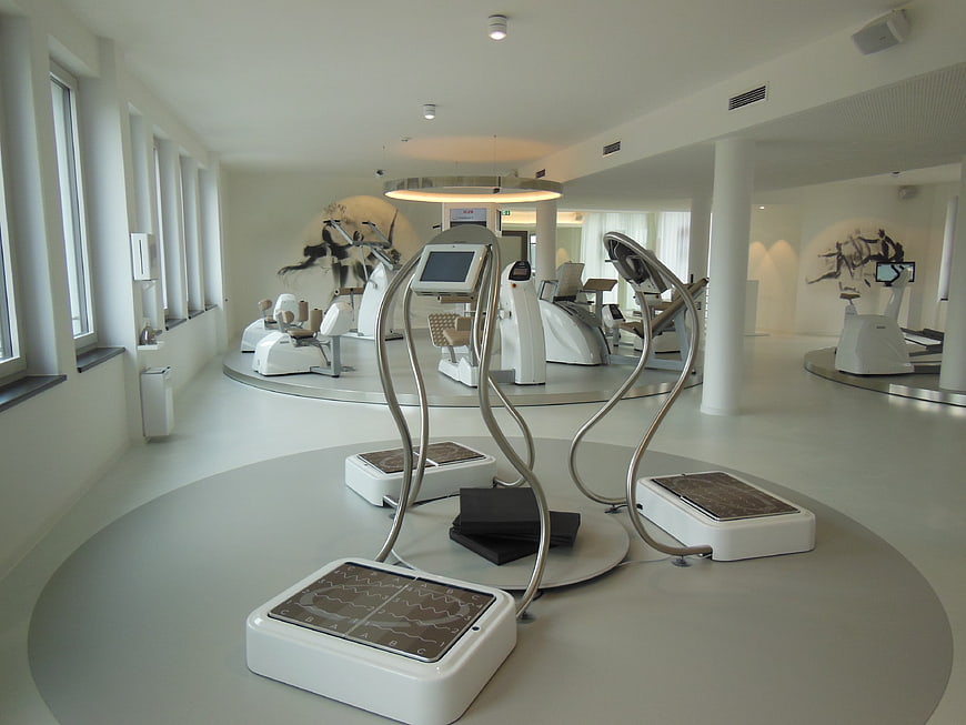 Modern minimalist fitness studio with white exercise equipment