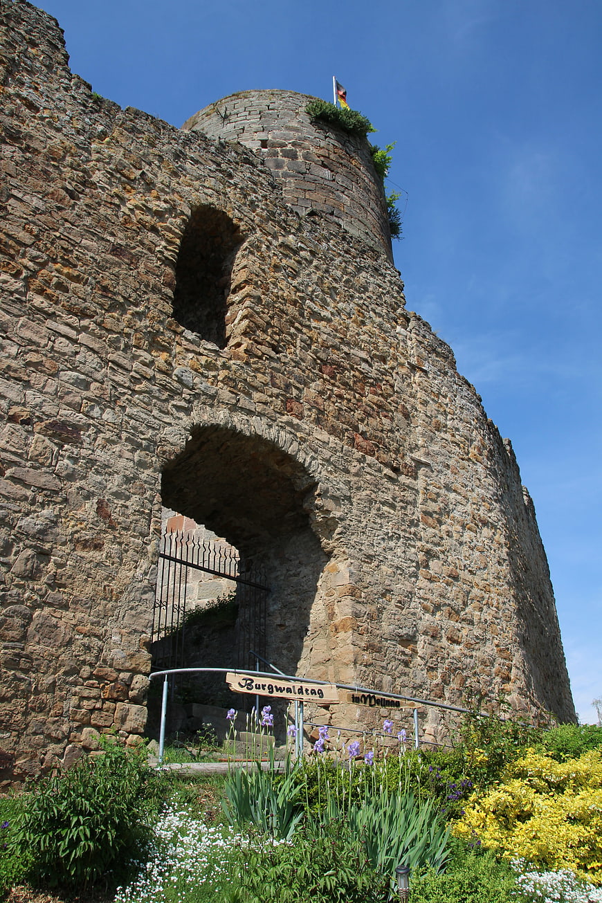 Ancient stone castle ruin with archway and garden