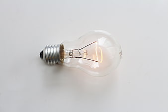 Classic incandescent light bulb on white background