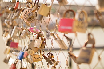 Close-up of colorful love padlocks on a bridge fence