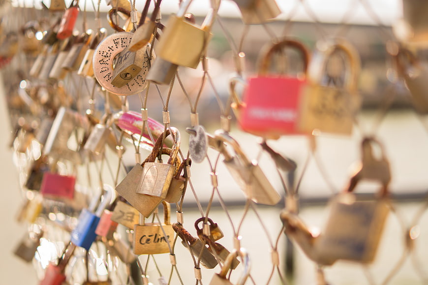 Close-up of colorful love padlocks on a bridge fence