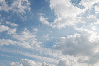 Blue Sky with Fluffy White Clouds Background