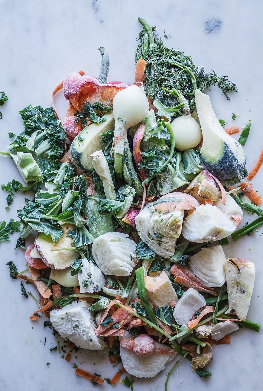 Frozen vegetable scraps for zero waste broth on marble