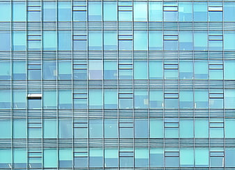 Modern glass office building facade with blue window grid pattern
