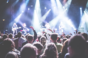 Live concert crowd cheering at rock music festival stage