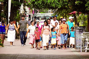 Large Hispanic Family Walking Together on Sunny Street